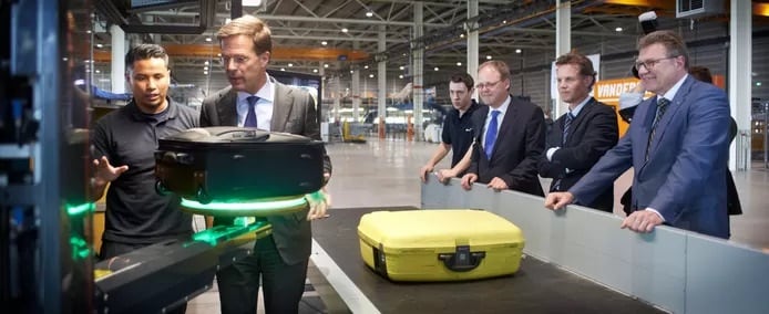 Herman Molenaar (rechts) kijkt toe hoe premier Mark Rutte uitleg krijgt tijdens een werkbezoek aan Vanderlande in Veghel. Foto: AD-Jeroen Appels/Van Assendelft