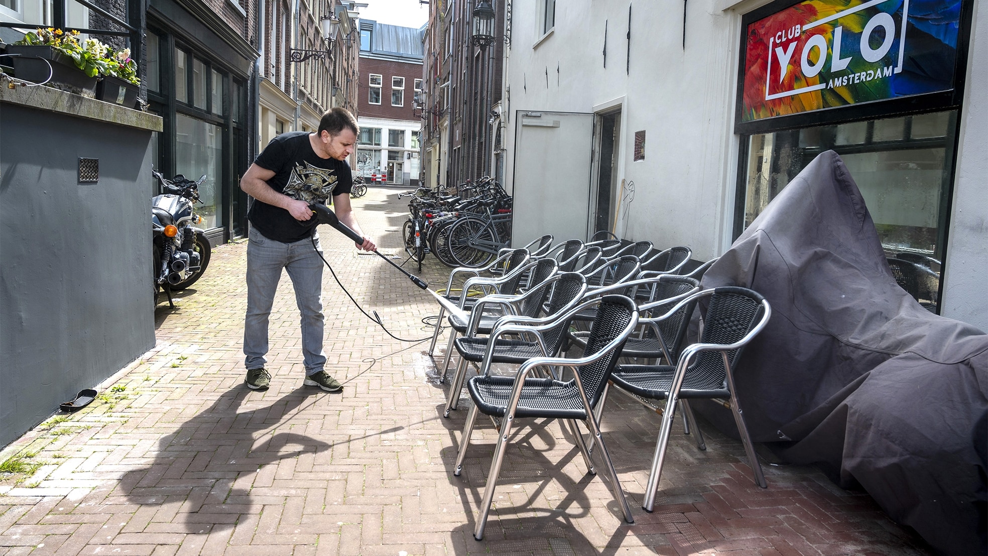 Een hoofdstedelijk terras wordt schoongemaakt voor de heropening op 28 april. Foto: ANP