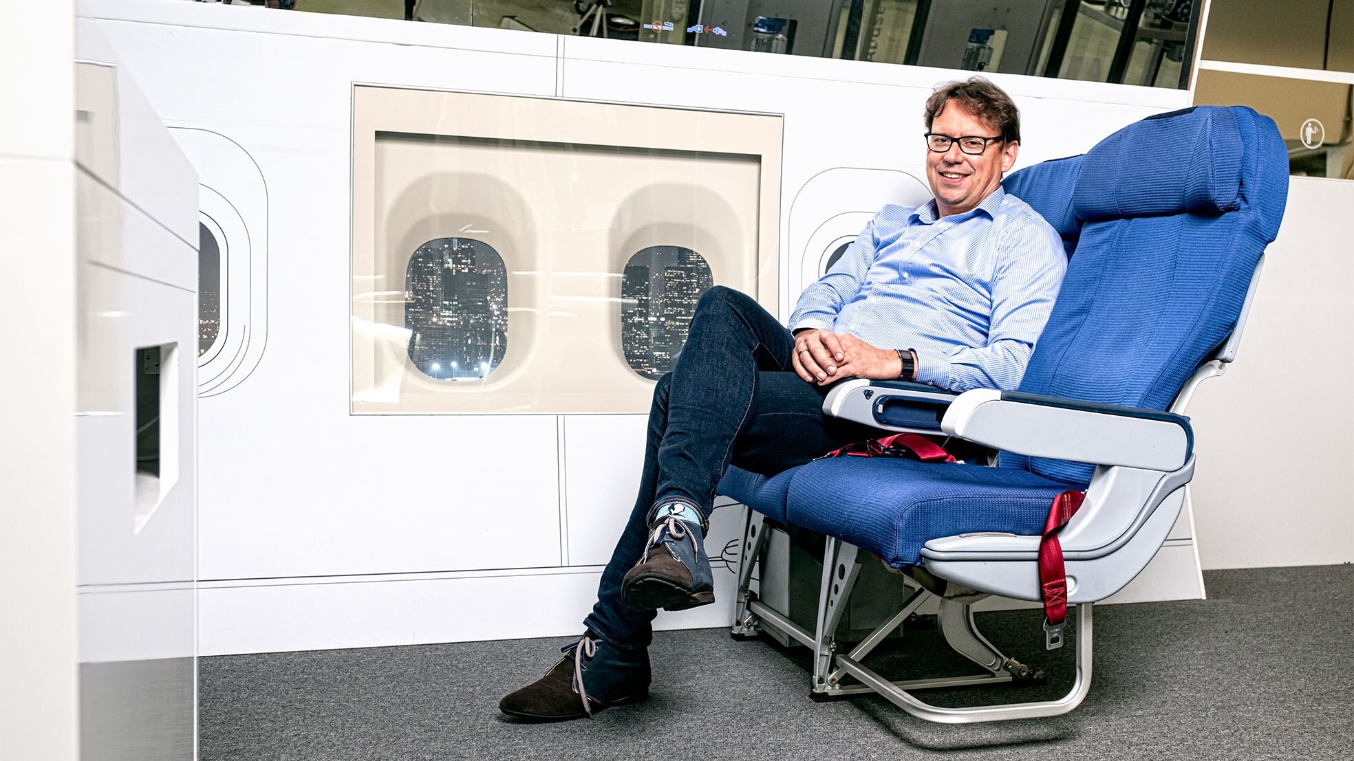 Jaap Wiersema in een nagemaaktecabine mét zijn glazen vliegtuigraampjes. Nico Brons