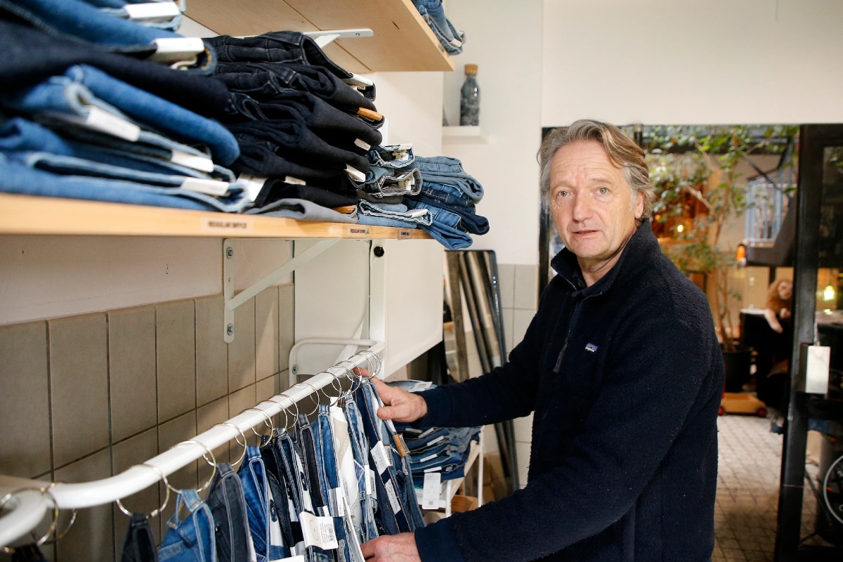 Oprichter Bert van Son tussen de MUD Jeans.
