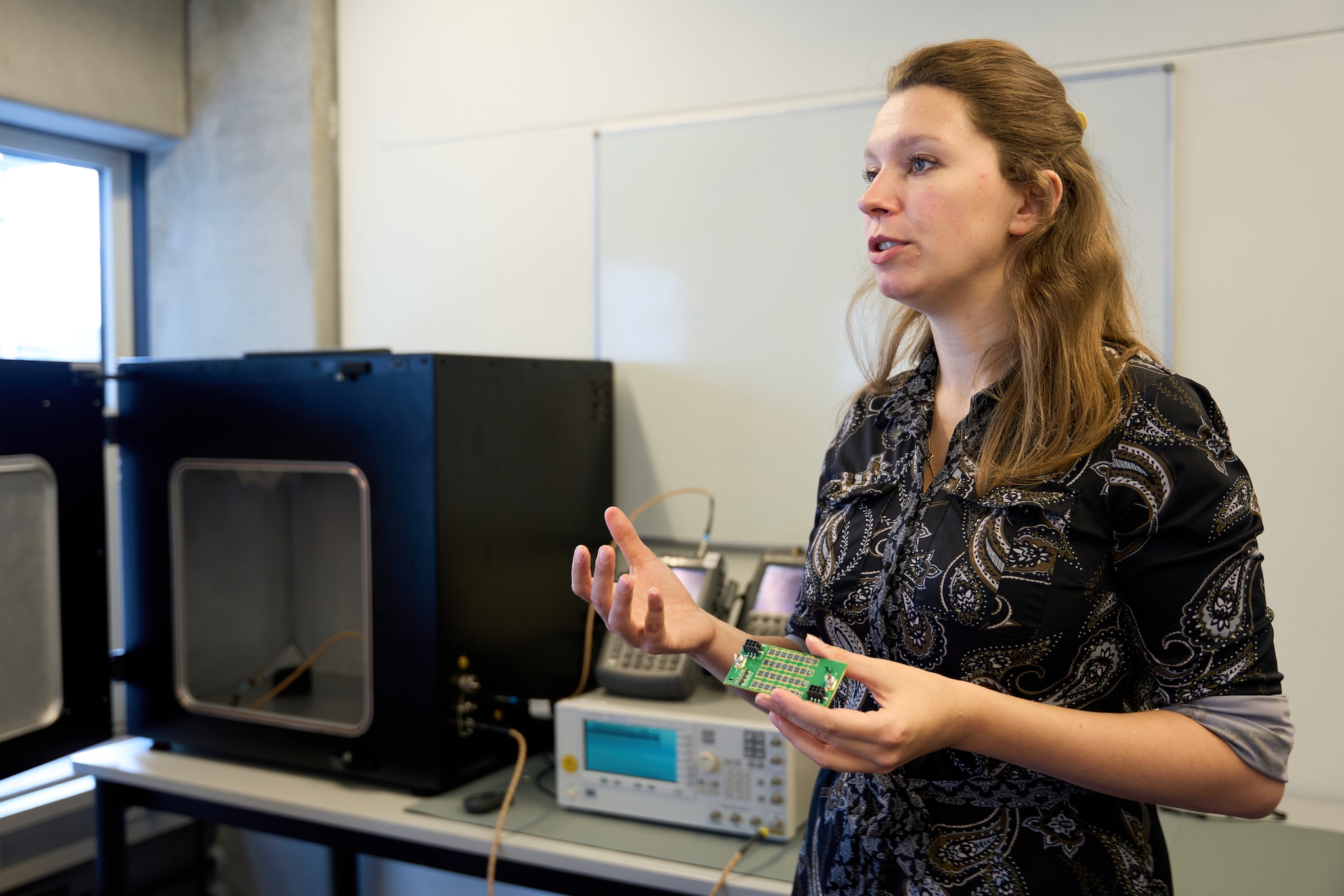 Anouk Hubrechsen van Antennex met een printplaatje met 32 antennes waarvan de straling in de kast gemeten kan worden. Anouk Hubrechsen van Antennex met een printplaatje met 32 antennes waarvan de straling in de kast gemeten kan worden. Foto: Thijn Vorstenbosch/DCI Media